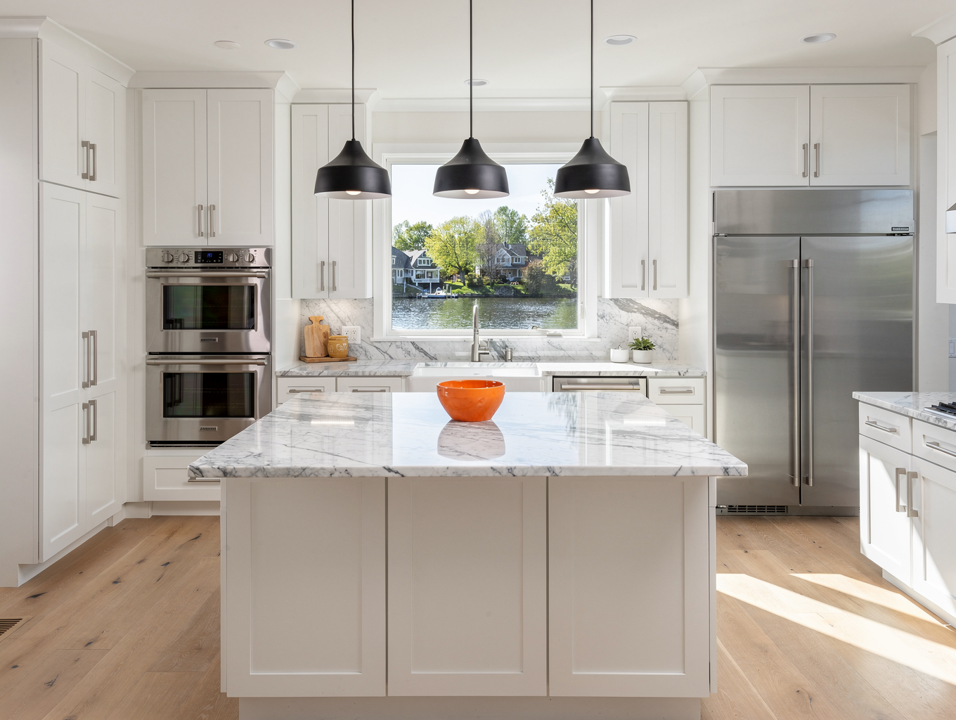 Modern chef kitchen remodel with custom white oak cabinetry and honed quartz counters