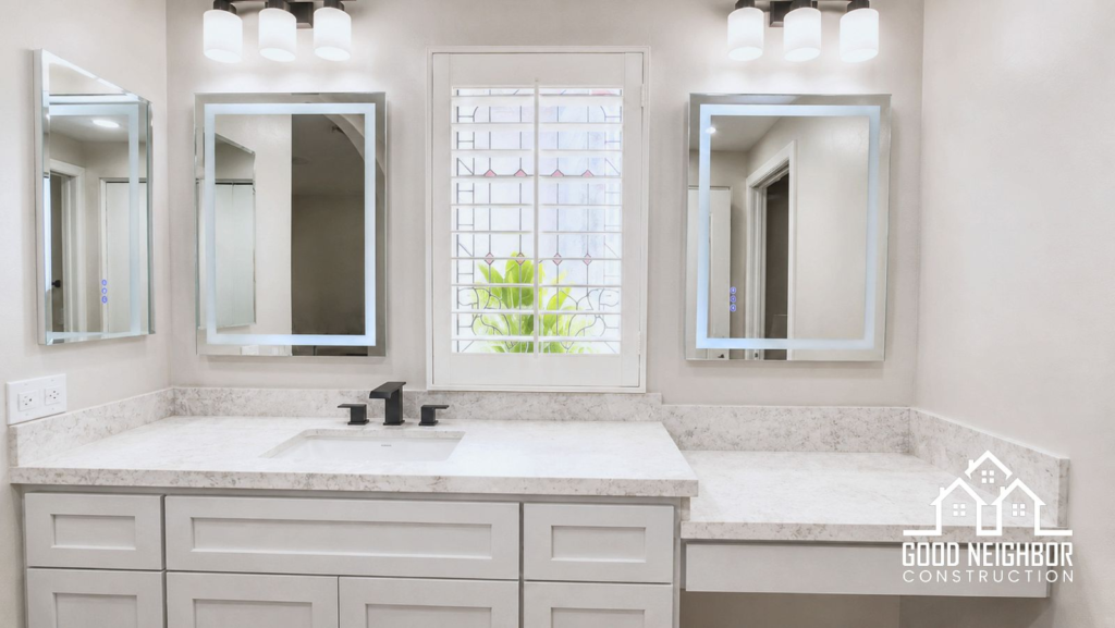 Finished bathroom remodel in Riverside with white vanity and framed mirrors